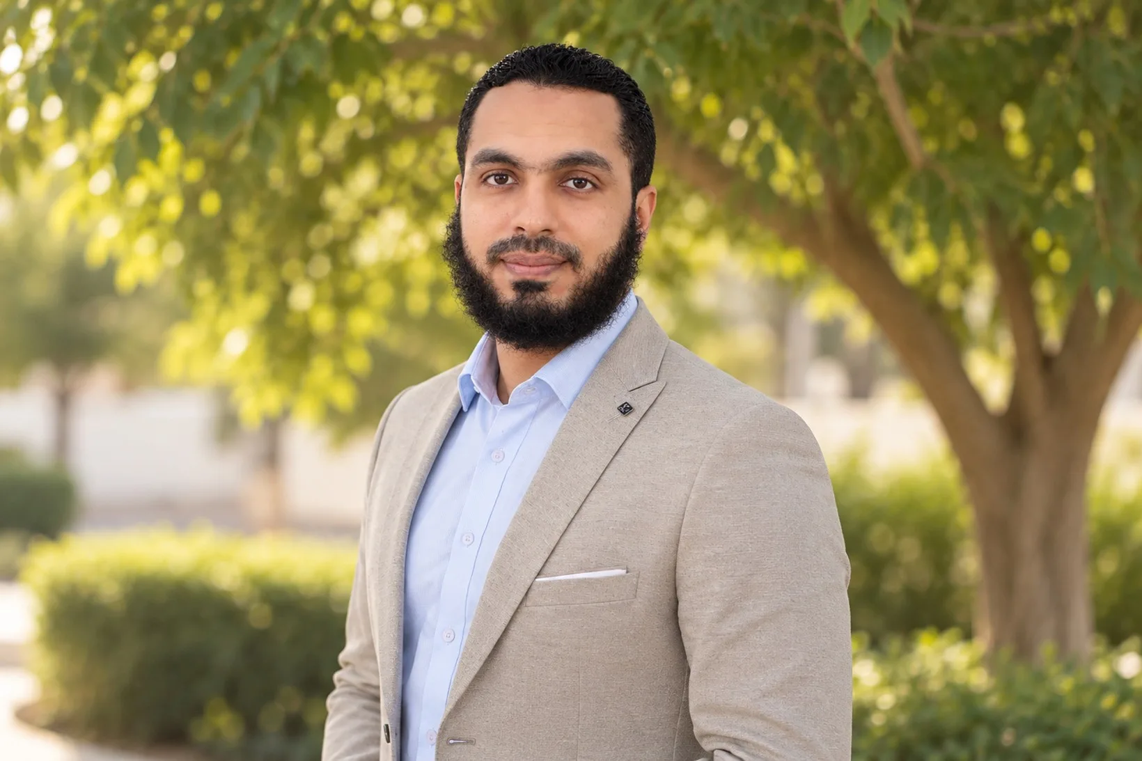Mohamed Khaled, MOJ legal translator, in a light jacket and blue shirt